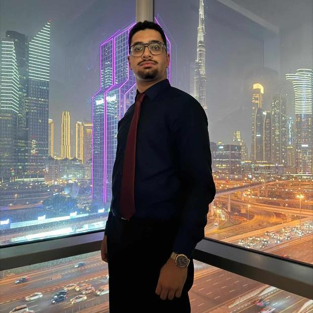 Youssef standing in front of the Dubai skyline